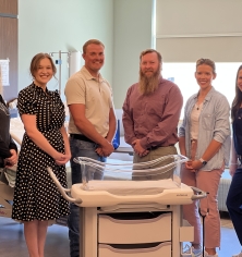 New bassinet with Foundation Board Members and Staff
