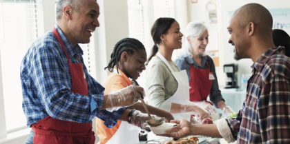 Man serving soup in serving line