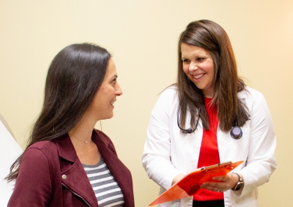 Doctor visiting with woman about women's health.