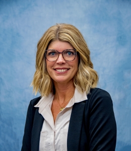 Claudine Kennicutt in a navy blazer and grey button-down blouse