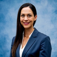 Headshot of Becky in blue blazer and white blouse